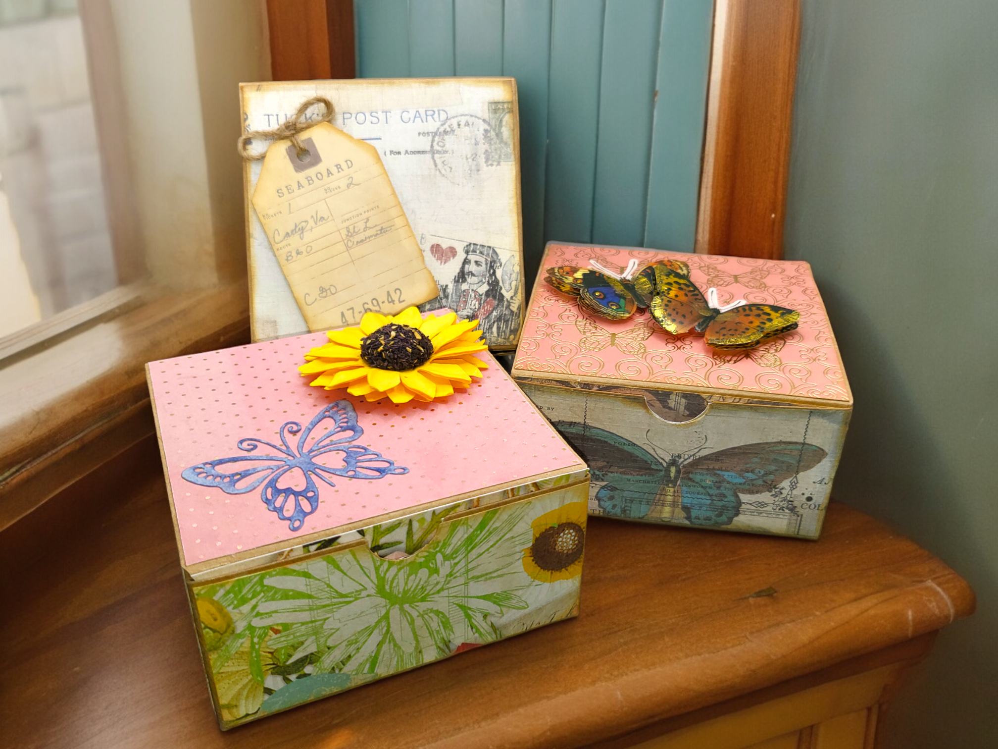 3 kraft gift boxes that have been covered in vintage ephemera paper