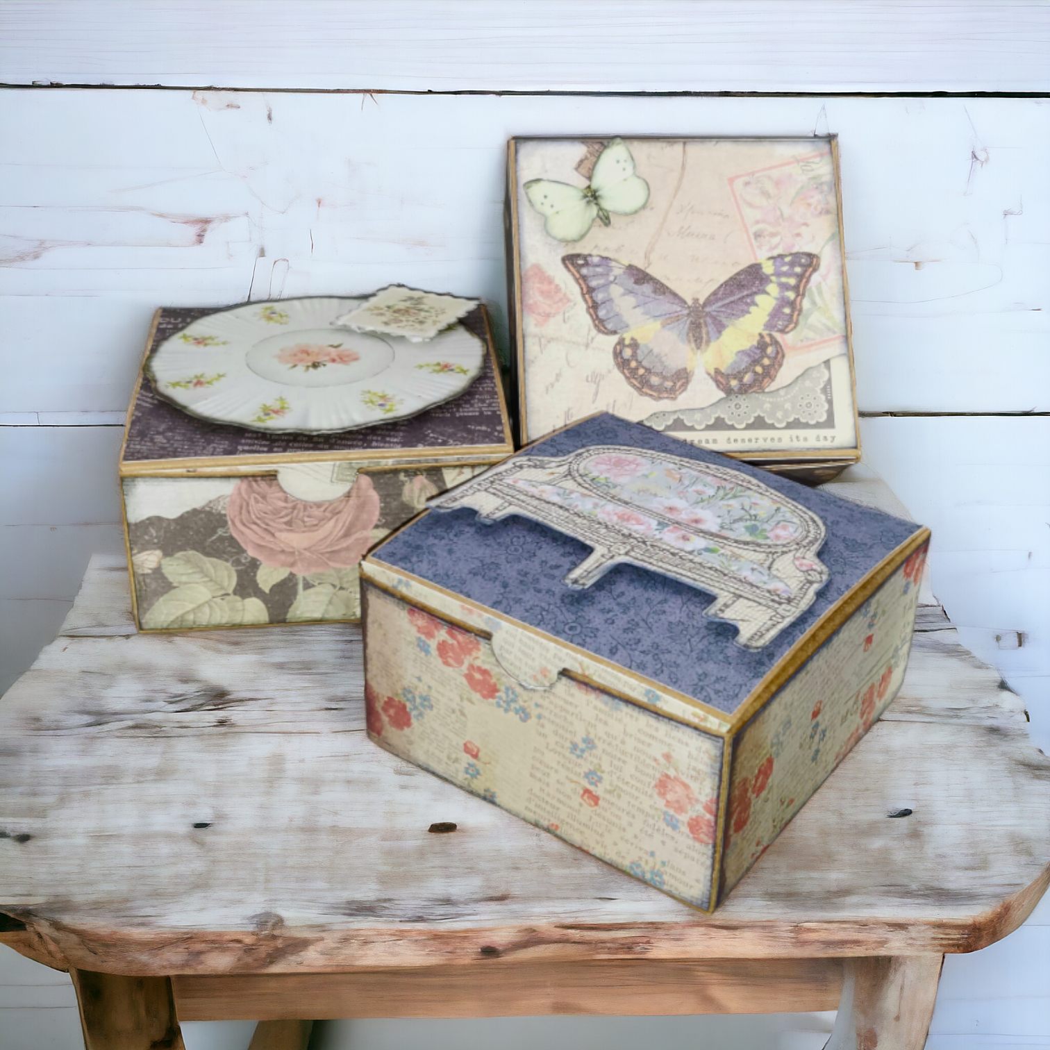 3 kraft boxes that have been decorated with vintage ephemera paper